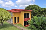 red-roofed cabins surrounded by greenery