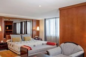 Room with double bed and wooden furniture