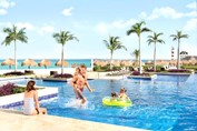 Family playing in the hotel pool