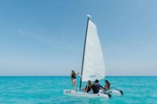 Young people riding catamaran