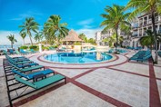 view of hotel pool and sunbeds
