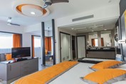Riu Cancun bedroom with orange accents