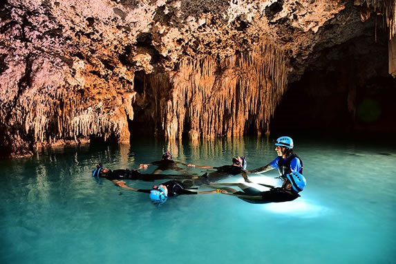 Tourists diving in the Rio Secreto