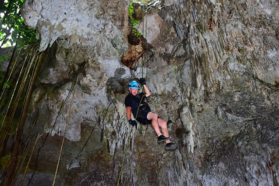 Tourists climbing the rocks of the river