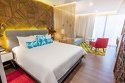 View of hotel room with bedroom and living