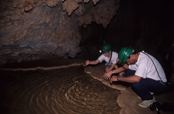 tourists watching the water in the cave