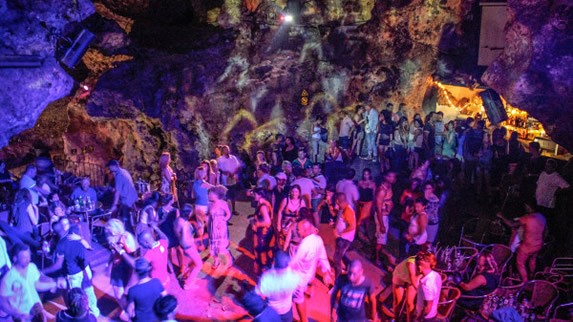 crowd dancing under colored disco lights