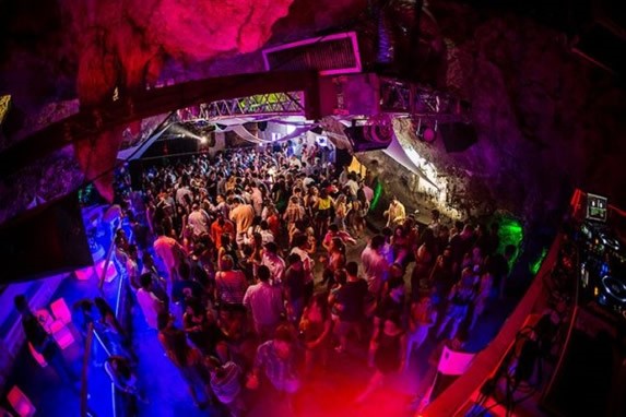 crowd dancing under colored disco lights