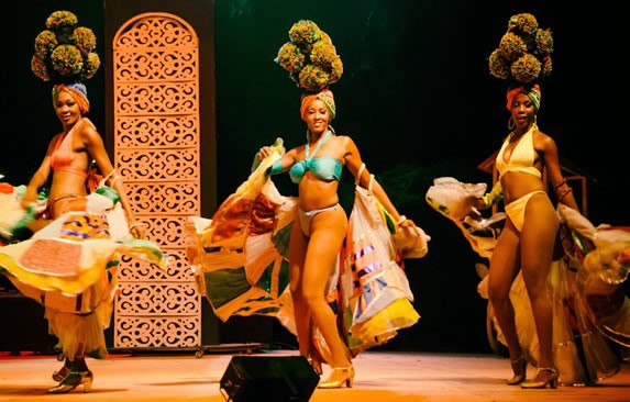 Dancers with colorful outfits on stage.