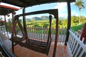 balcony with wooden swing and mountain view