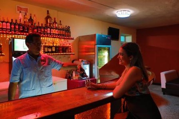 client enjoying a cocktail at the bar