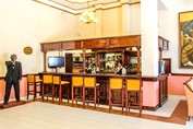 hotel bar with wooden bar and stools