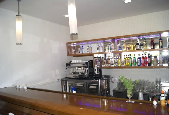 bar with wooden bar and drink bottles