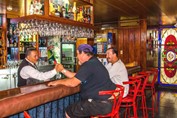 bar with wooden bar and colorful stained glass