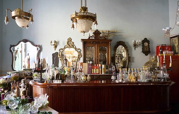 Wooden bar surrounded by antiques.