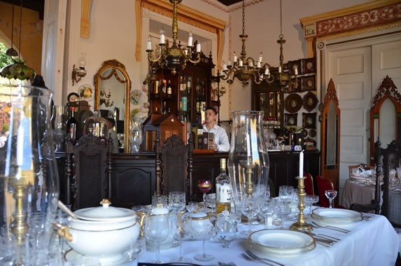 Wooden bar surrounded by antiques.