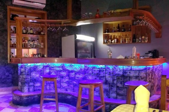 bar con luces LED y taburetes de madera