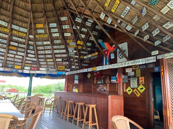 wooden bar and furniture under guano roof