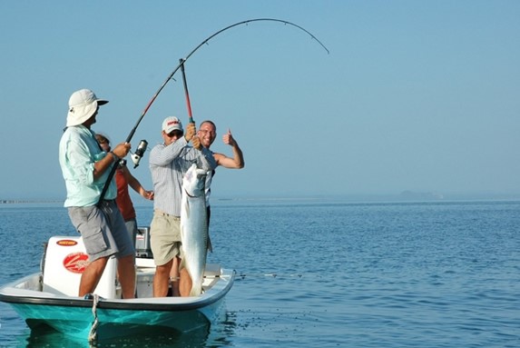 fishermen with fishing rods in a boat