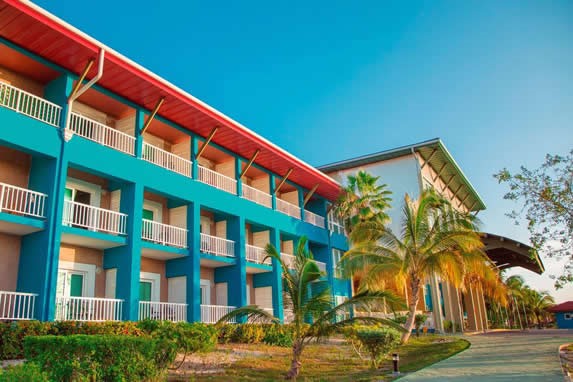 colorful hotel facade surrounded by palm trees