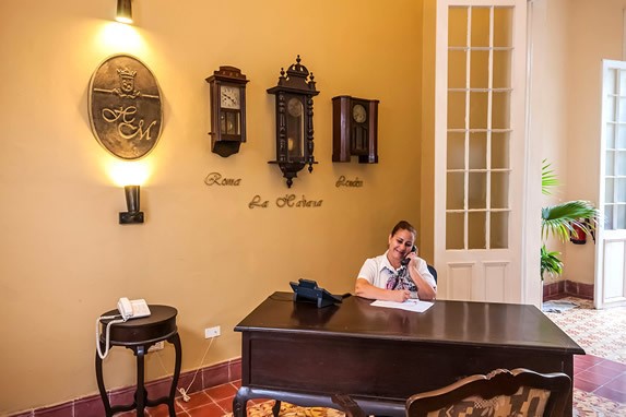 receptionist at the wooden lobby desk