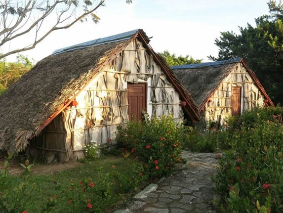 rustic guano cabins surrounded by greenery