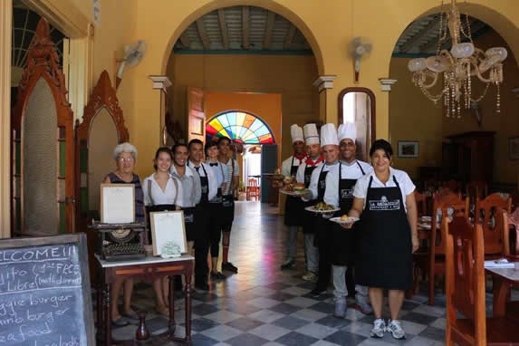 Waiters lined up at the restaurant entrance