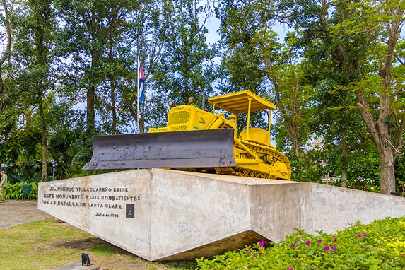 yellow tonka front loader on stone with sign