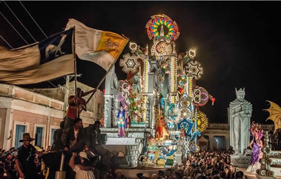 illuminated festival floats surrounded by people