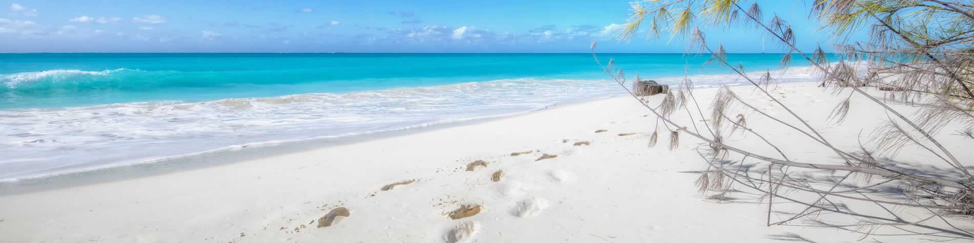 Footprints on the fine white sands of the beach
