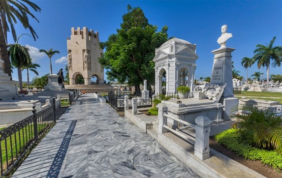 marble mausoleums and graves in green garden