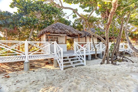 wooden beach bar with guano roof