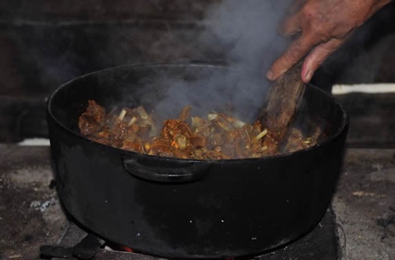 delicious food cooking in a rustic cauldron