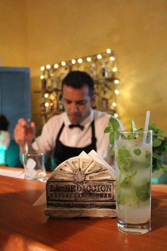 waiter preparing drink behind the bar