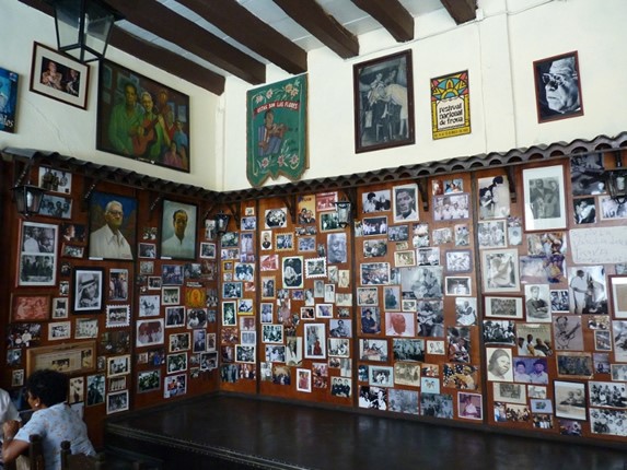 Wooden wall decorated with photographs.