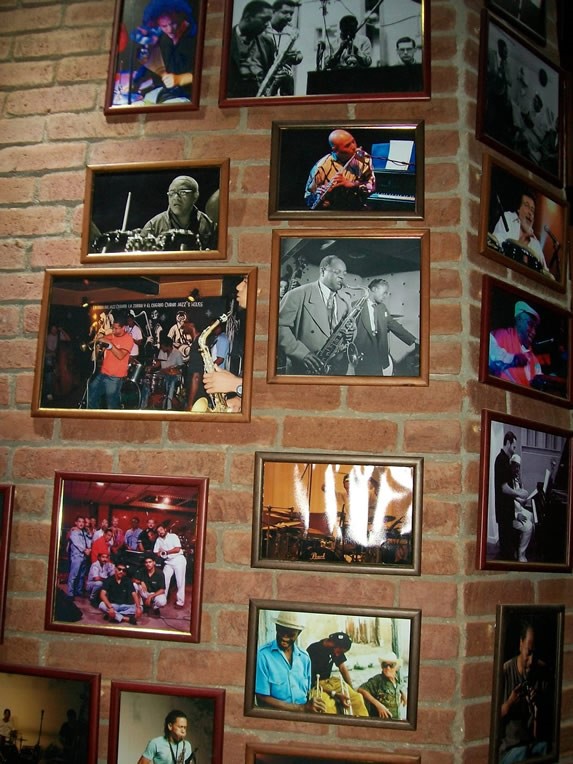 Brick wall decorated with photographs.