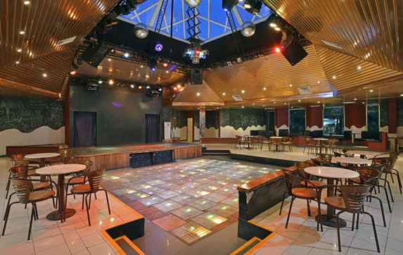 dance floor with lights and tables around