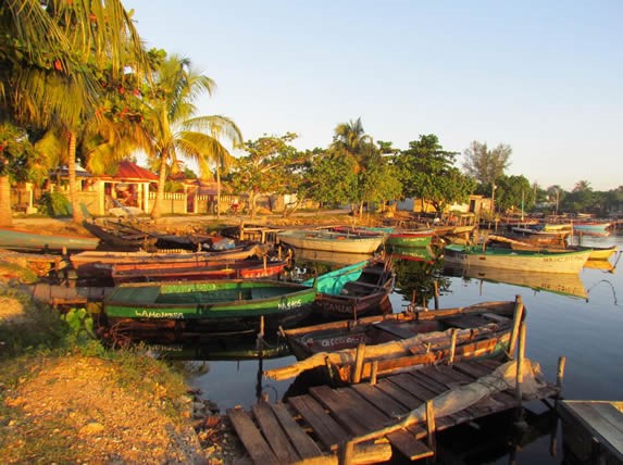 dock with small boats at sunset