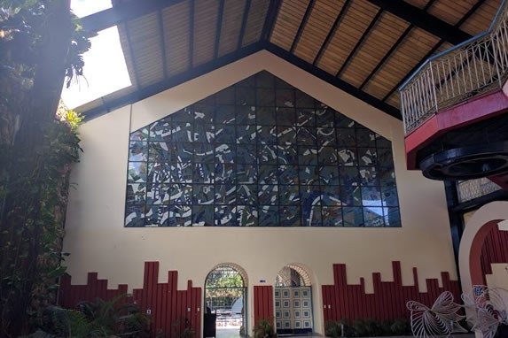 Stained glass wall and wooden ceiling.