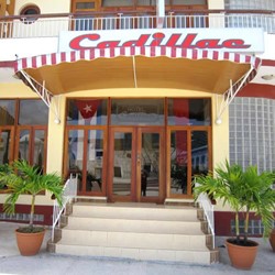 hotel entrance with wooden doors and poster