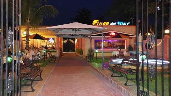 restaurant facade with front yard and fence