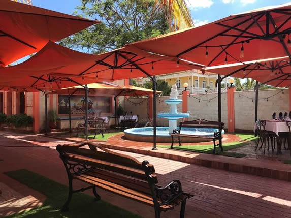 front yard with fountain and umbrellas