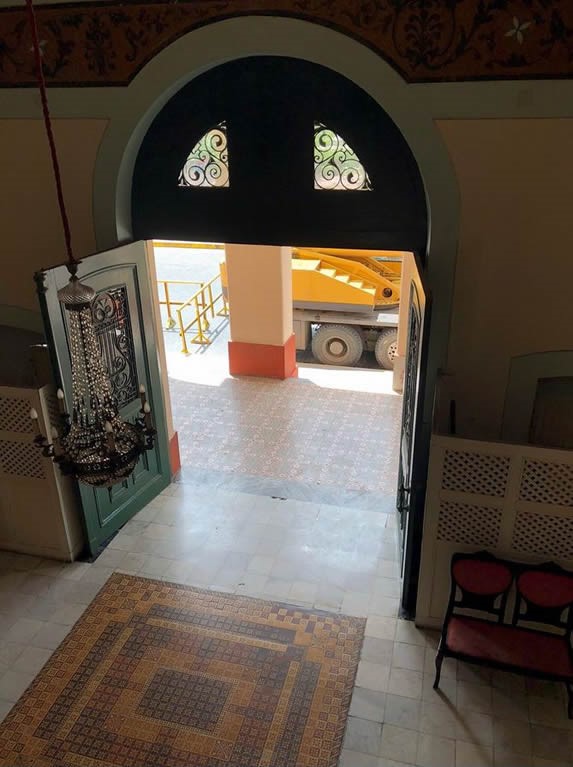 green entrance door of the caridad theater 