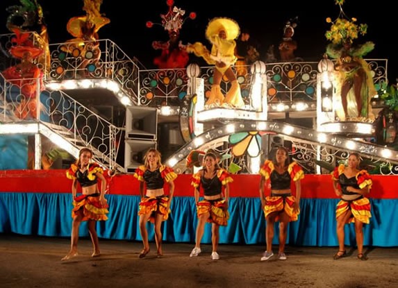 dancers on stage with colorful costumes