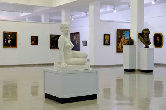 lounge with sculptures and paintings on display