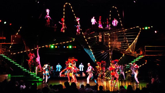 Dancers with colorful outfits on stage.