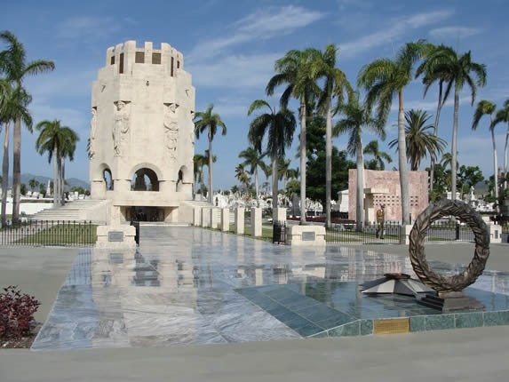 marble mausoleum surrounded by royal palms