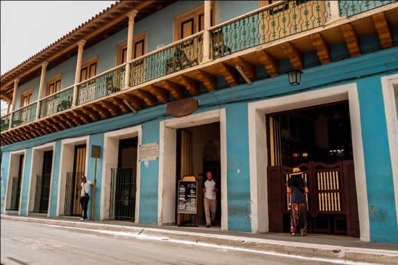 Colonial blue facade with balconies.