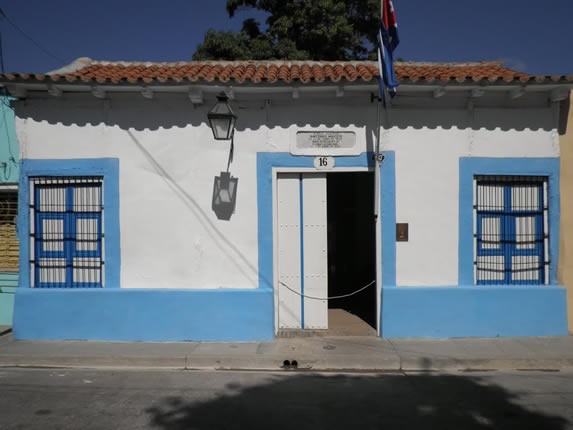 Colonial blue facade with red tiles.