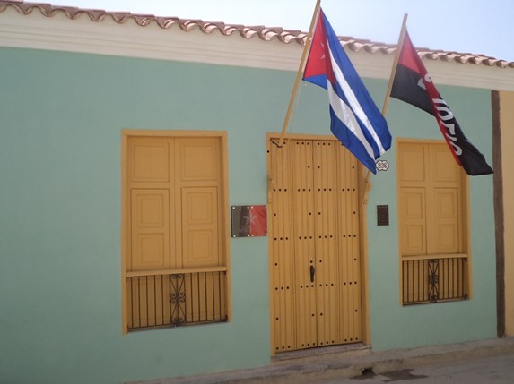 Colonial facade with hanging flags.